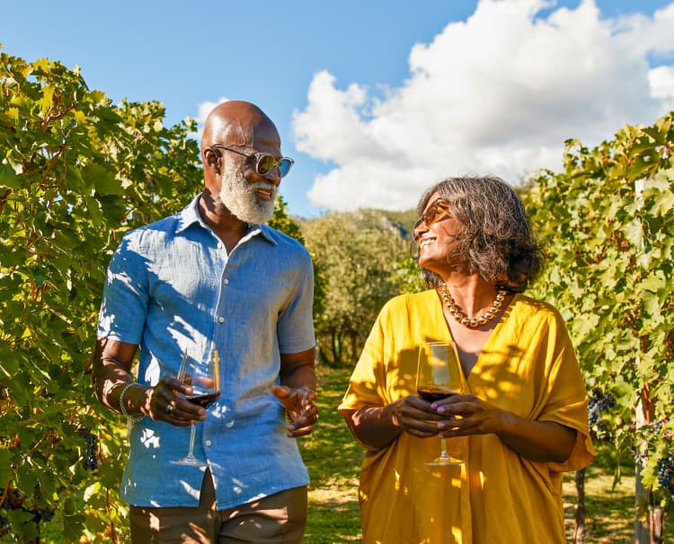 A one-line drawing romantic couple enjoying a glass of red wine in a scenic  vineyard landscape