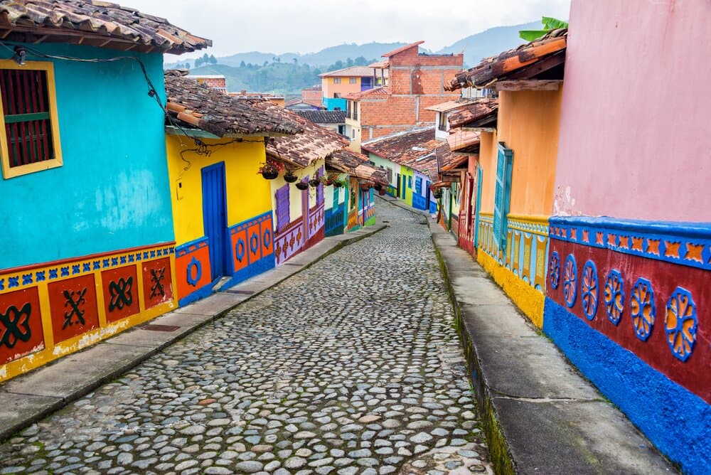 Colorful colonial houses on a cobblestone street in Medellin