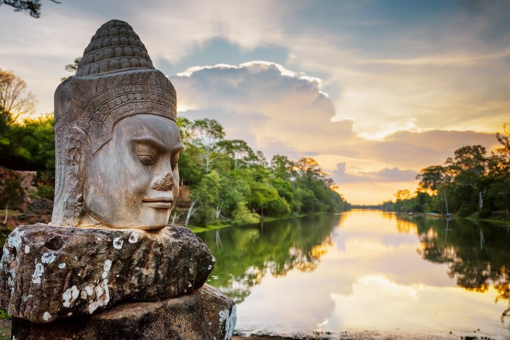 Stone face Asura on causeway near South Gate of Angkor Thom in Siem Reap, Cambodia.